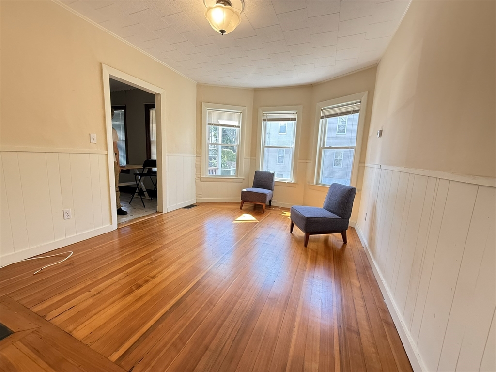 53 Litchfield Street, Unit 53 Boston, MA 02135 - Photo 3 of 14 a living room with furniture and a wooden floor