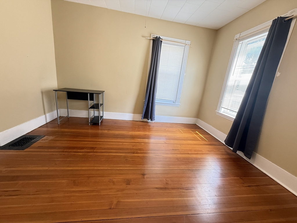 53 Litchfield Street, Unit 53 Boston, MA 02135 - Photo 7 of 14 a view of a room with wooden floor and chair