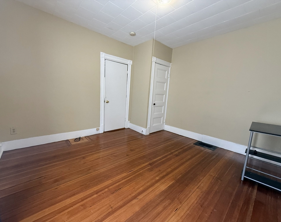 53 Litchfield Street, Unit 53 Boston, MA 02135 - Photo 8 of 14 a view of room with wooden floor and closet