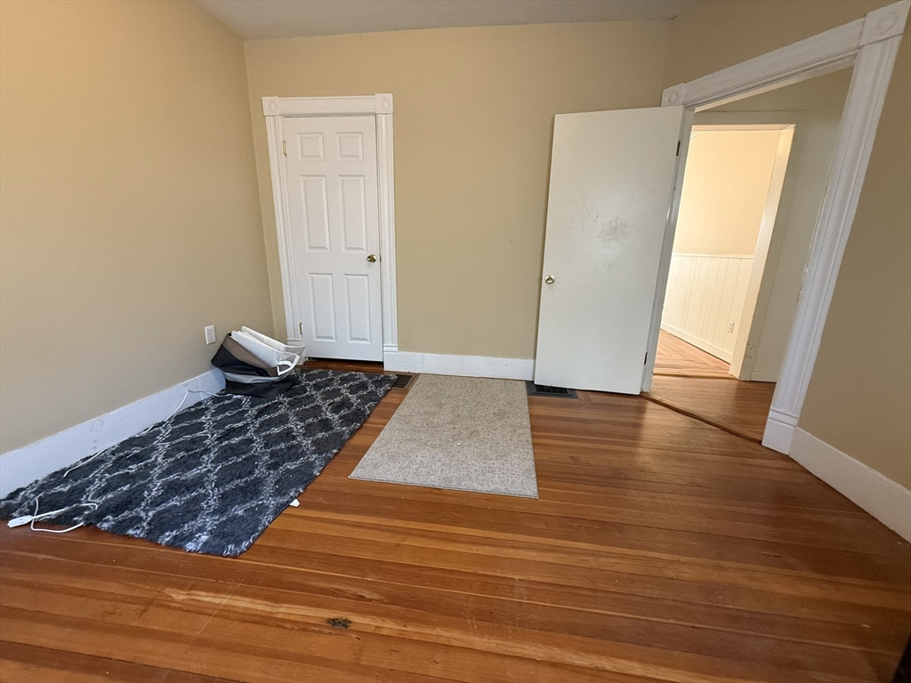 53 Litchfield Street, Unit 53 Boston, MA 02135 - Photo 9 of 14 a view of a hardwood floor and closet in a room