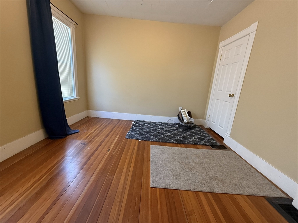 53 Litchfield Street, Unit 53 Boston, MA 02135 - Photo 10 of 14 a bedroom with wooden floor and a sink