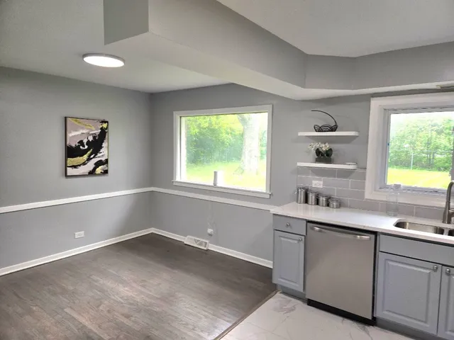 a kitchen with a sink cabinets and window