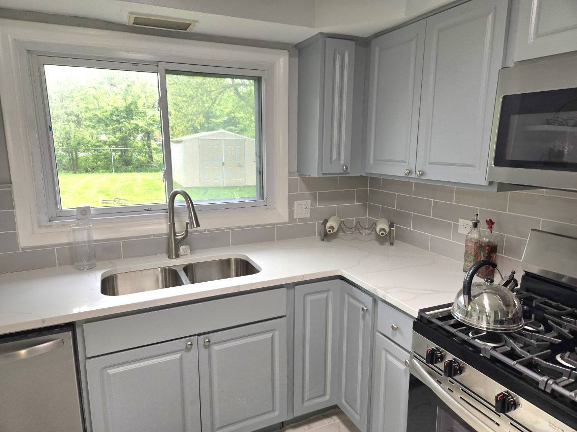 926 Braemar Road Flossmoor, IL 60422 - Photo 17 of 35 a kitchen with a sink stove top oven and cabinets