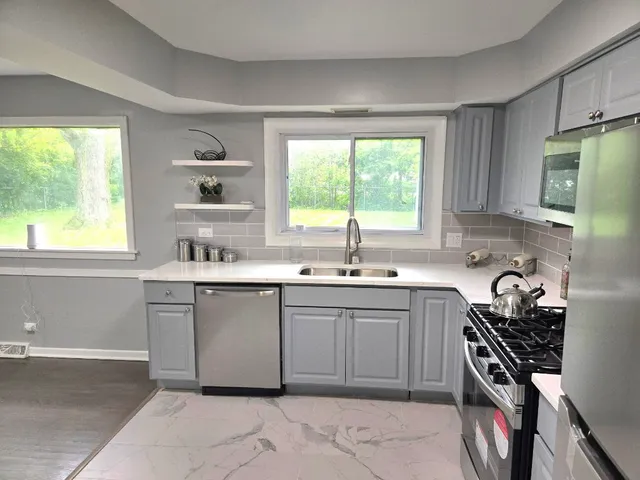 a kitchen with a sink stove and cabinets