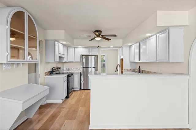a view of kitchen with stainless steel appliances cabinets