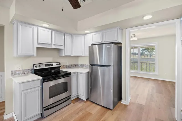 a kitchen with a refrigerator sink and cabinets