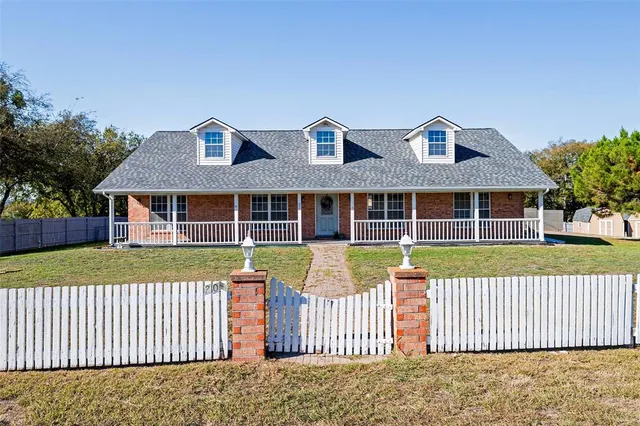 a view of a brick house with a yard