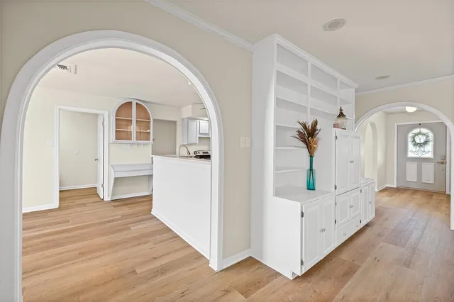 a view of a livingroom with wooden floor and a ceiling fan