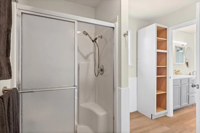 a view of empty room with wooden floor