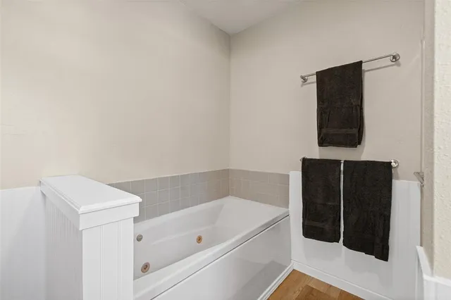 an empty room with a ceiling fan and carpet