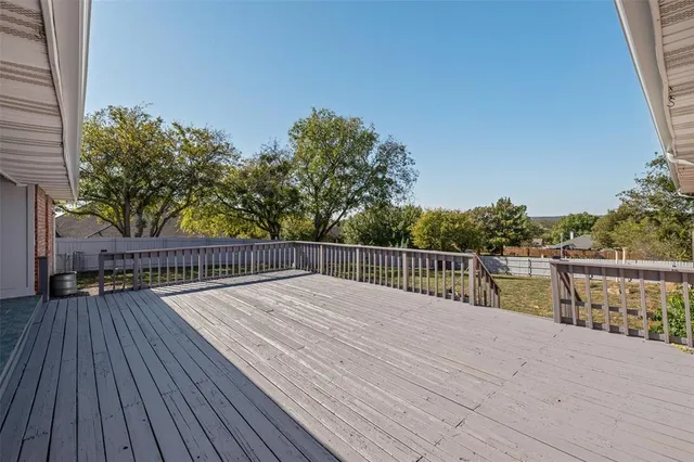 a view of balcony with deck and wooden floor