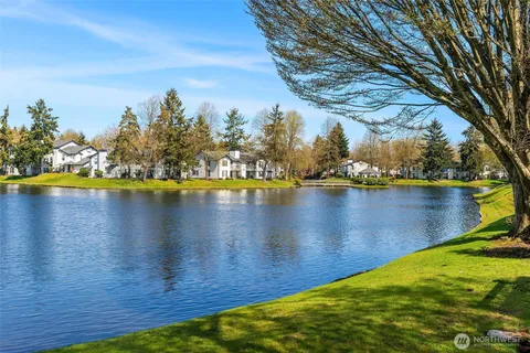 a view of a lake with houses in the back