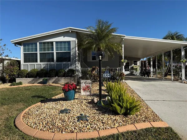 a view of a house with a yard patio and fire pit