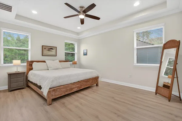 a spacious bedroom with a bed and a large window