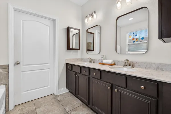 a bathroom with double sink and a mirror