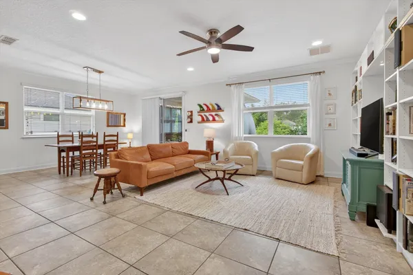 a living room with furniture a fireplace and a large window