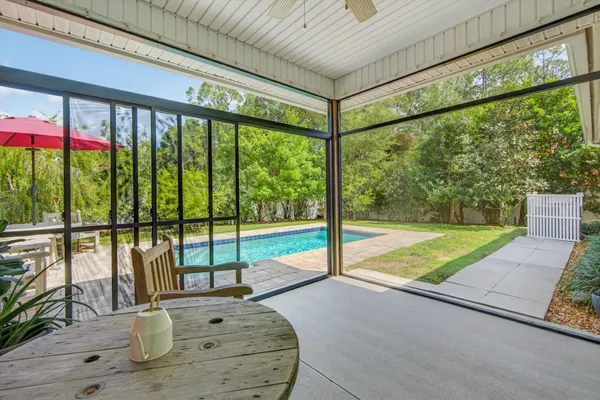 a swimming pool with yard in the back