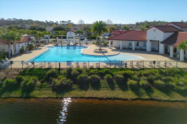 an aerial view of residential houses with outdoor space and lake view