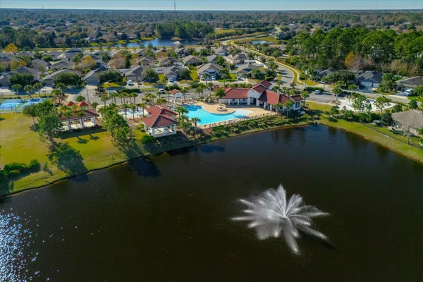 an aerial view of a house with swimming pool and porch