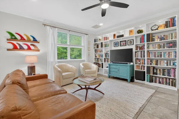 a living room with furniture workspace and a flat screen tv