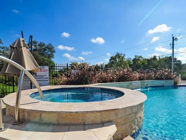 a view of swimming pool with outdoor seating and plants