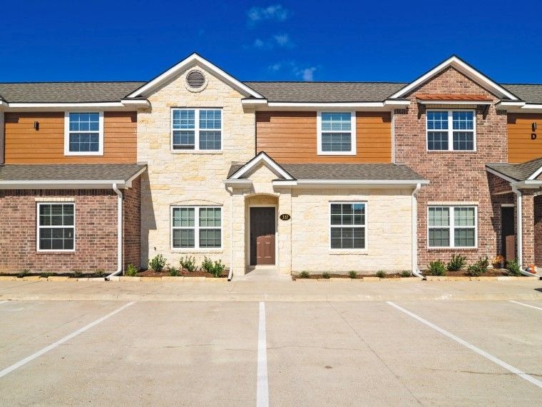 301 Southwest Parkway, Unit 314 College Station, TX 77840 - Photo 2 of 14 a front view of a house with a yard