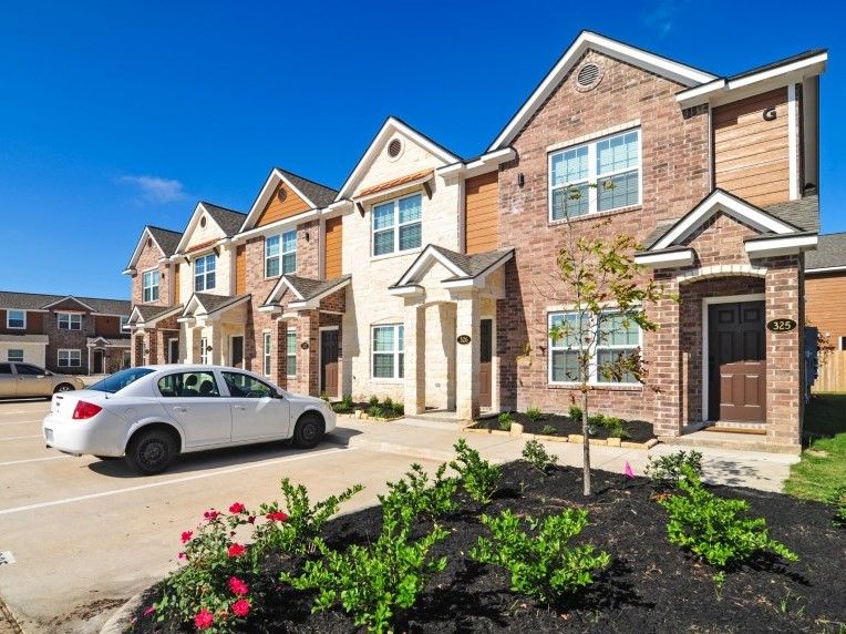301 Southwest Parkway, Unit 314 College Station, TX 77840 - Photo 3 of 14 a view of a white house next to a yard