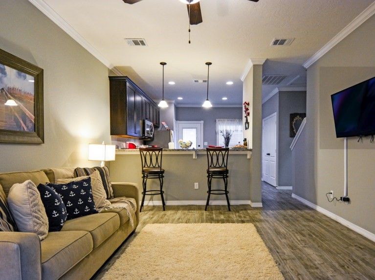 301 Southwest Parkway, Unit 314 College Station, TX 77840 - Photo 5 of 14 a living room with furniture and a flat screen tv