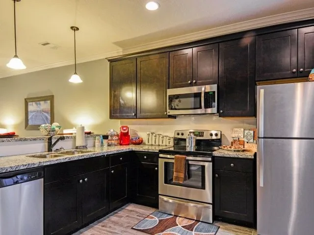 a kitchen with a sink stainless steel appliances and cabinets