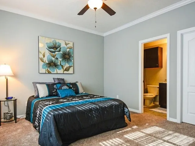 a bedroom with a bed and a chandelier