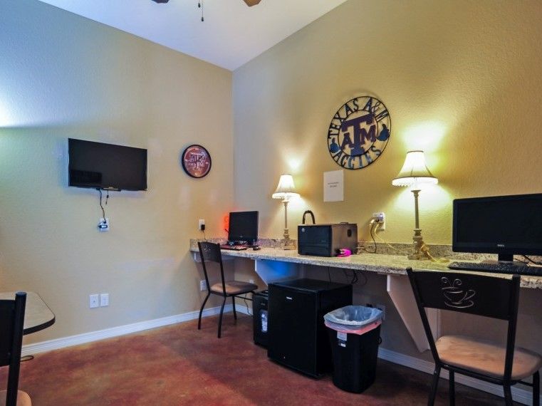 301 Southwest Parkway, Unit 314 College Station, TX 77840 - Photo 10 of 14 a room with a table chairs and a workspace