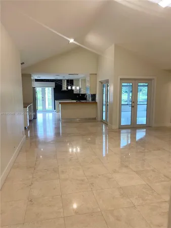 a large kitchen with kitchen island a sink stainless steel appliances and cabinets