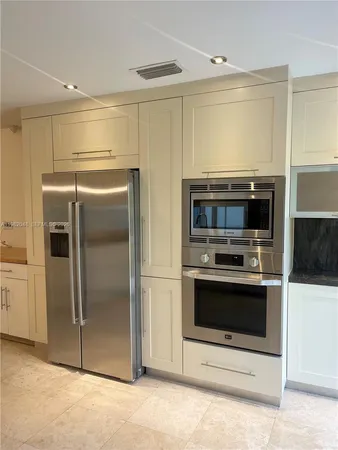 a kitchen with granite countertop a sink and cabinets