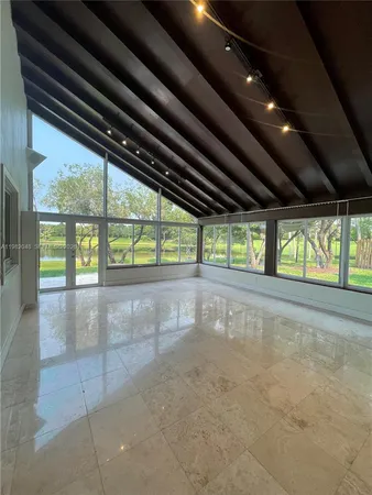 a view of a hallway with living room and dining room
