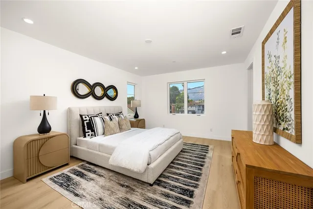 a bedroom with a bed and wooden floor