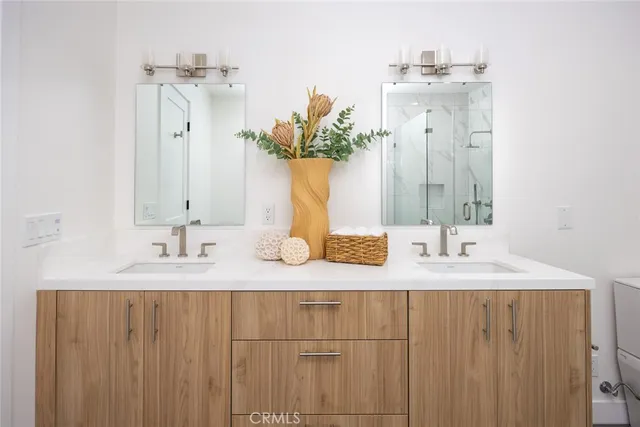 a bathroom with a double vanity sink and a mirror