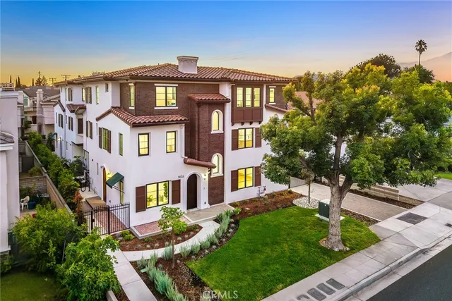 a front view of a residential apartment building with a yard