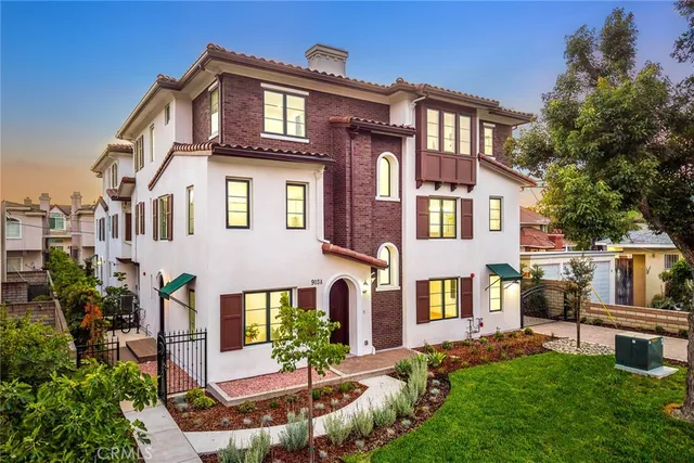 a front view of a residential apartment building with a yard