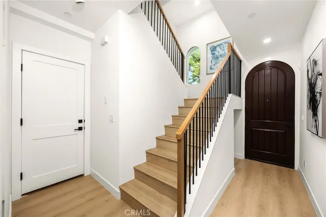 a view of entryway with wooden floor and stairs
