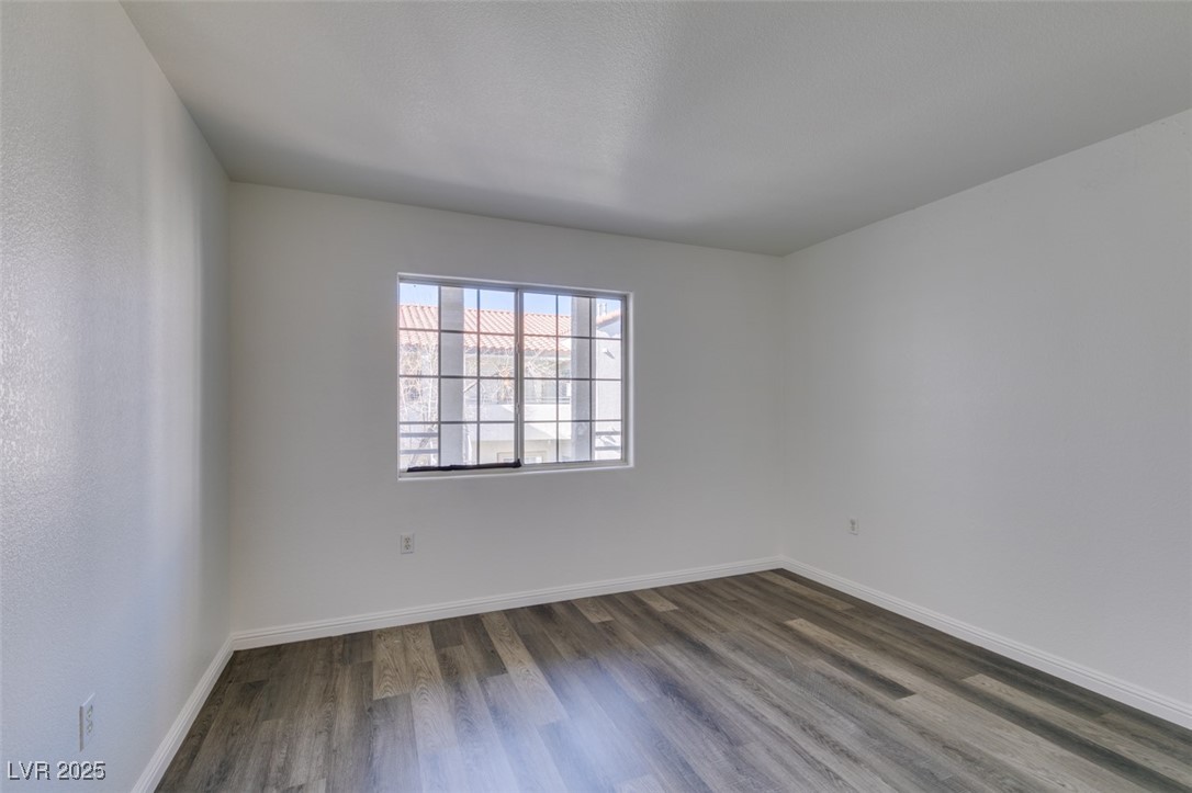 3318 North Decatur Boulevard, Unit 2138 Las Vegas, NV 89130 - Photo 28 of 40 Unfurnished room featuring dark wood-type flooring and baseboards