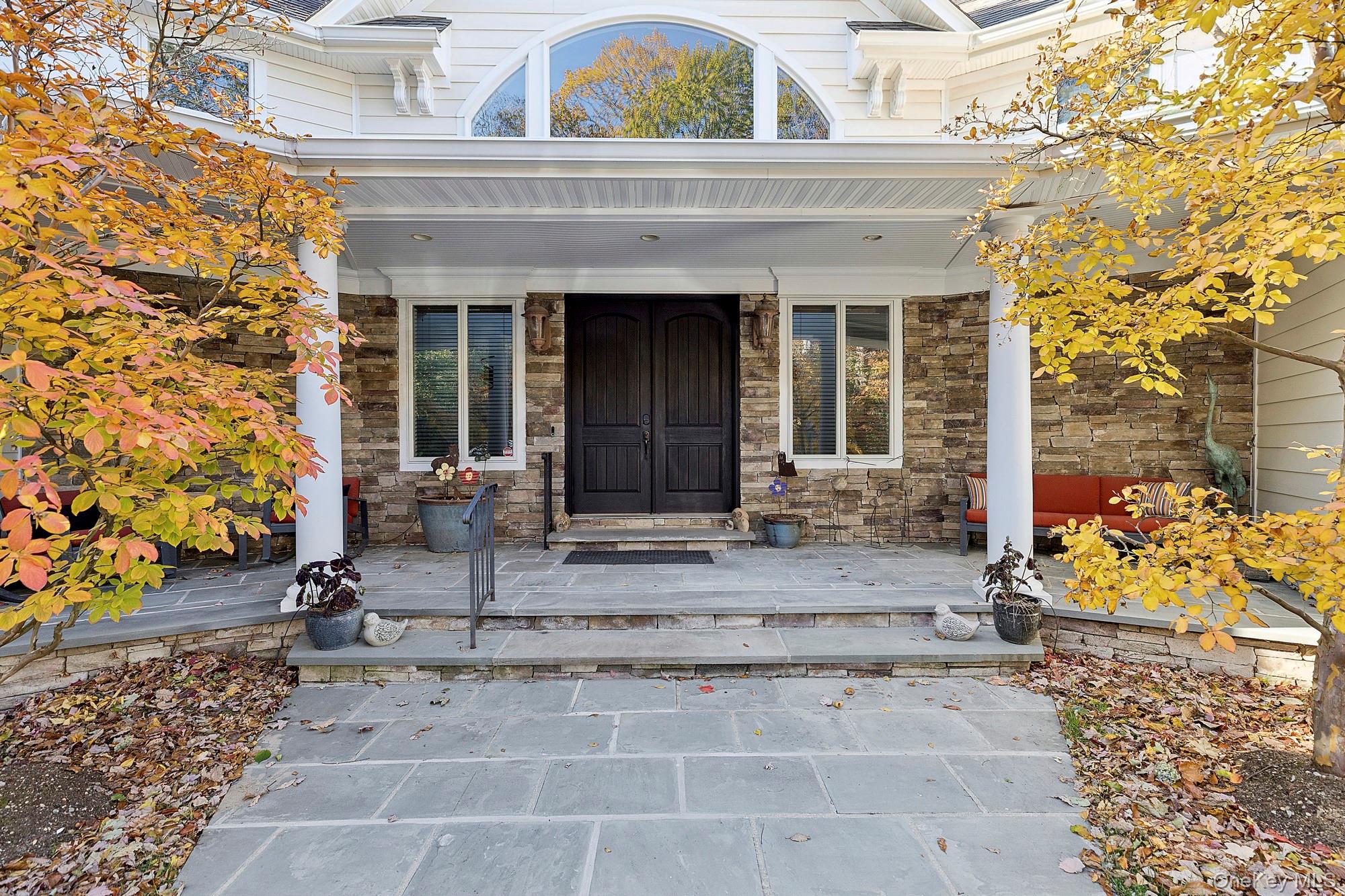 144 Round Swamp Road West Hills, NY 11743 - Photo 7 of 39 Entrance to property featuring covered porch and stone siding