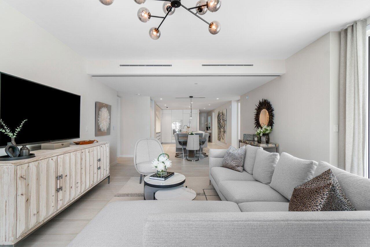 200 Southeast Mizner Boulevard, Unit 211 Boca Raton, FL 33432 - Photo 12 of 67 a living room with furniture and a flat screen tv