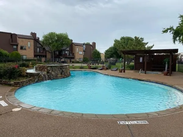 a swimming pool with outdoor seating and yard