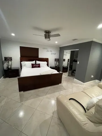 a large bedroom with a bed and a large mirror