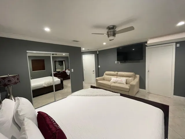 a bedroom with a bed and a couch