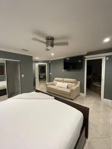 a bedroom with a large bed and a large window