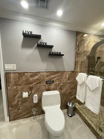 a bathroom with a toilet and a mirror