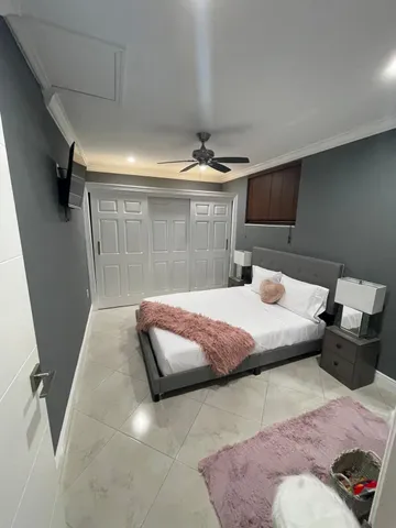a bedroom with a bed and mirror