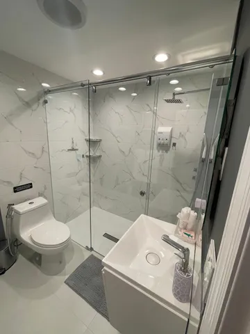 a bathroom with a sink toilet and shower