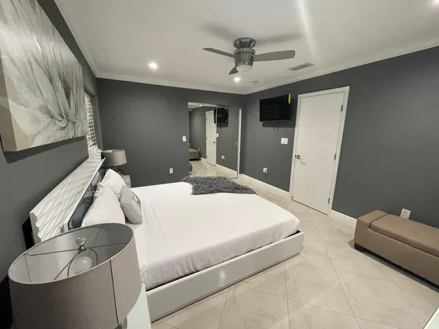 a bedroom with a bed and a chandelier